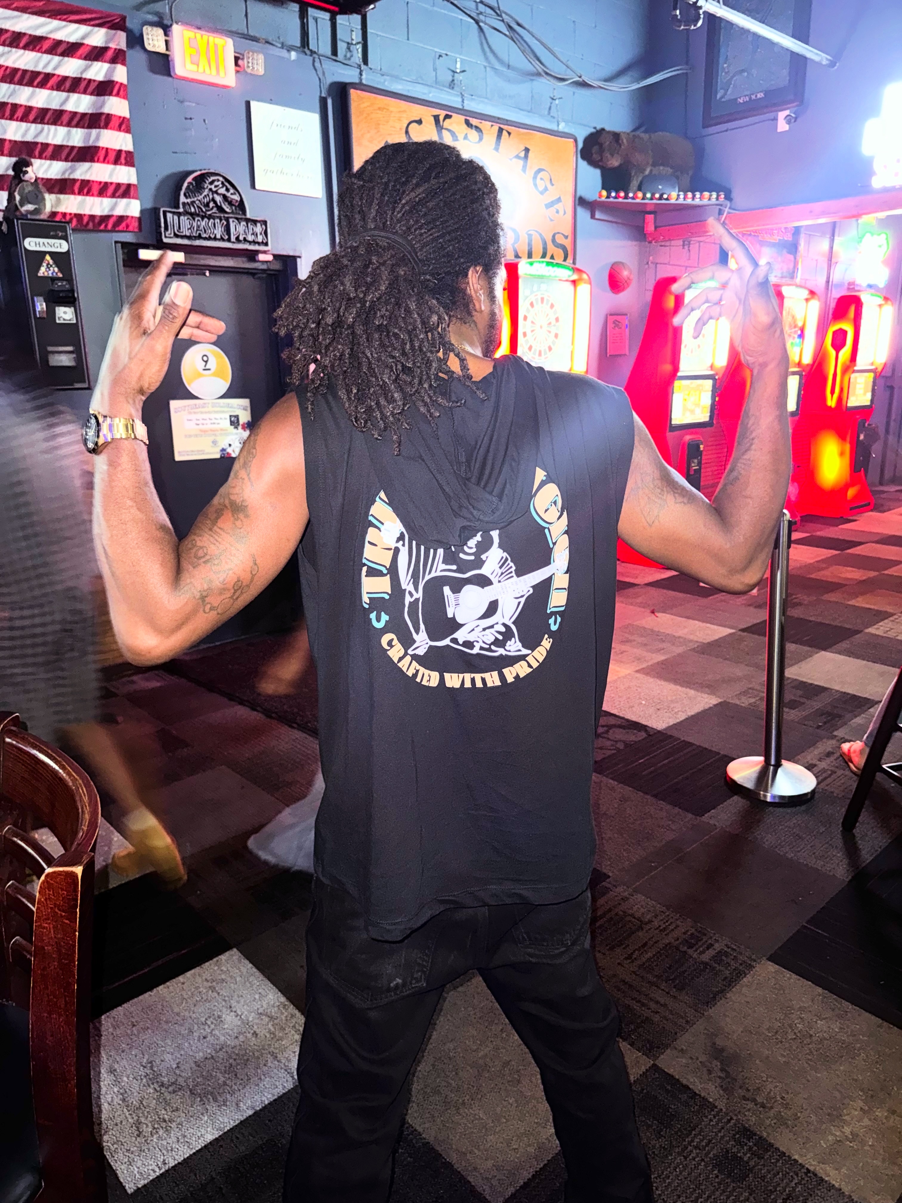 Chevy GC in a sleeveless hoodie at an arcade