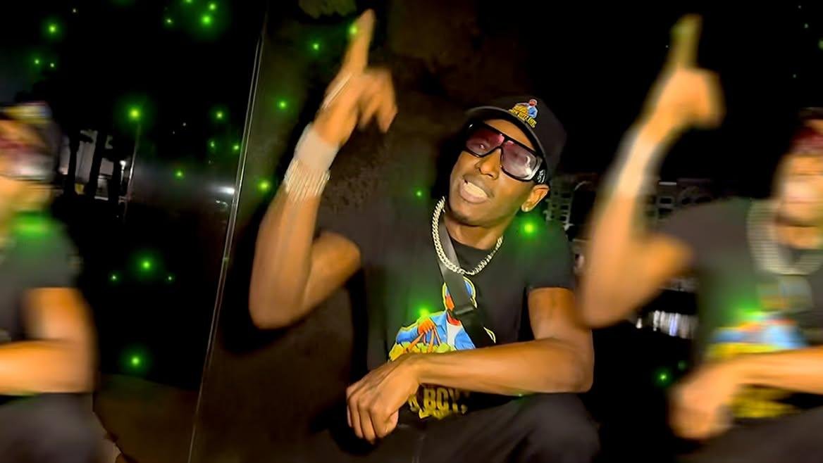 Twan G Young Gutta wearing a black Sack Boyz Entertainment shirt in a nighttime portrait sequence