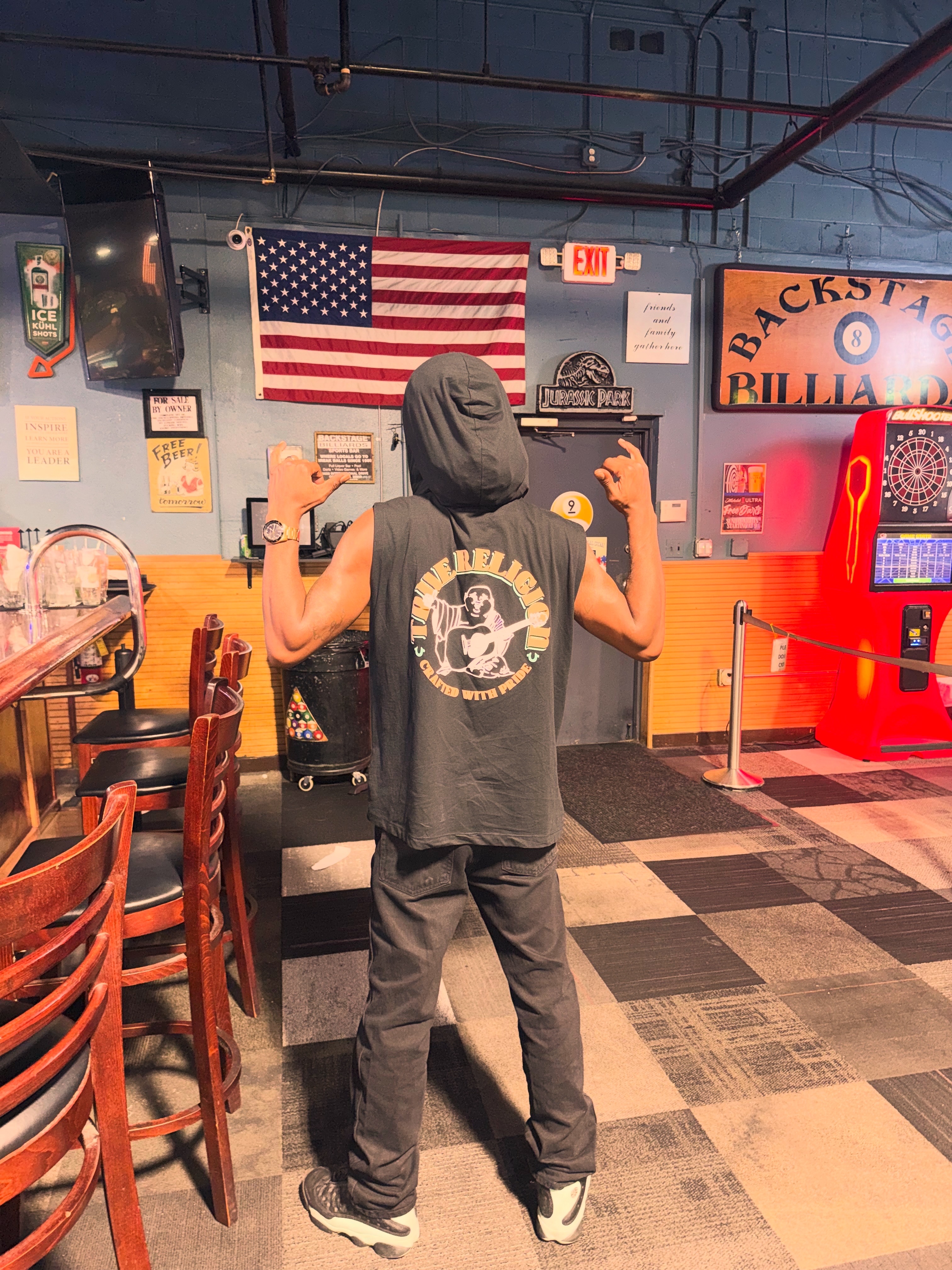 Chevy GC in a sleeveless hoodie at a billiards hall