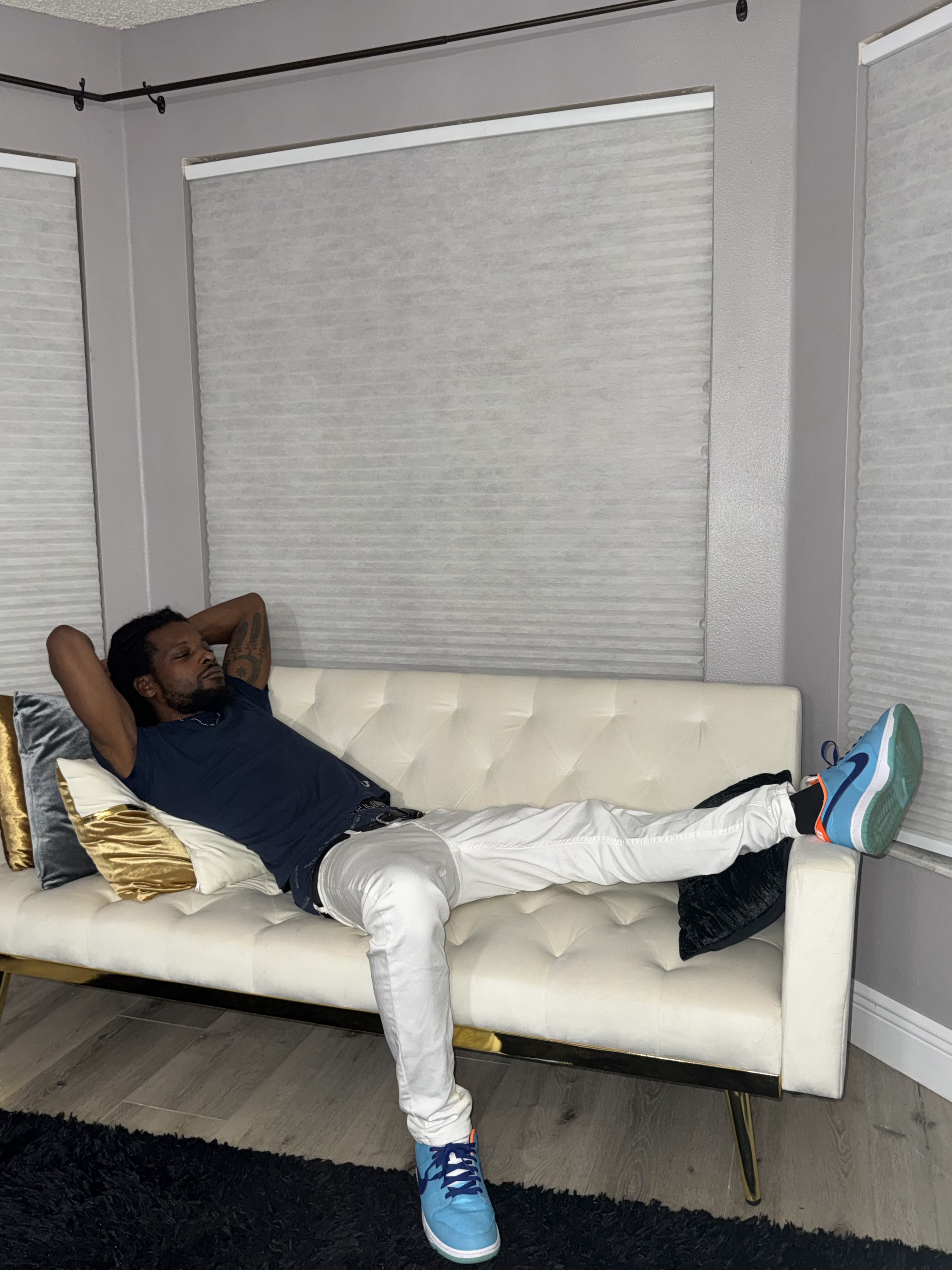Chevy GC relaxing on a couch in a streetwear outfit